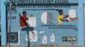 A painting commissioned by Oxfam reminds people to purify their water before drinking it. Image by Meghan Dhaliwal. Haiti, 2012.